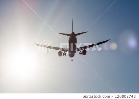 Landing airplane in backlight Landing airplane in backlight 120802748
