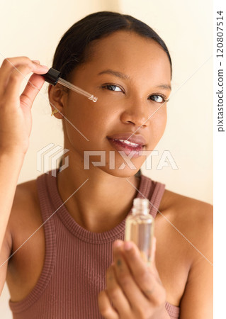 Woman Applying Face Serum for Glowing and Healthy Skin Care Routine Woman Applying Face Serum for Glowing and Healthy Skin Care Routine 120807514