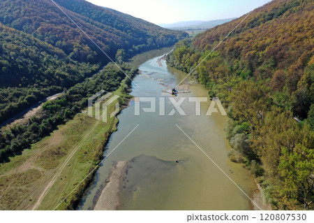 Aerial view of backhoes digging sand and gravel with shovels from the river Aerial view of backhoes digging sand and gravel with shovels from the river 120807530