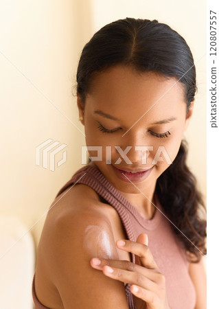Woman Applying Moisturizing Lotion on Shoulder for Smooth and Radiant Skin 120807557