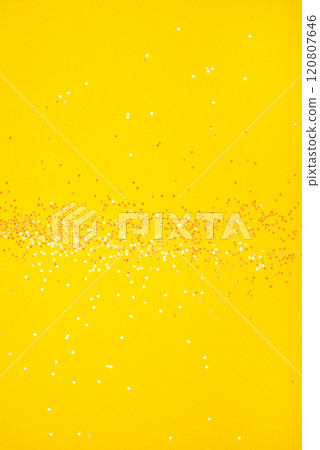 Tiny pearl stars on yellow background. 120807646