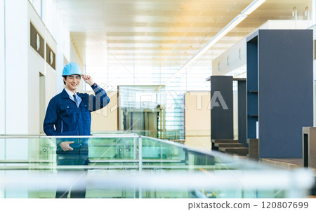 Male worker with tablet PC in building Male worker with tablet PC in building 120807699