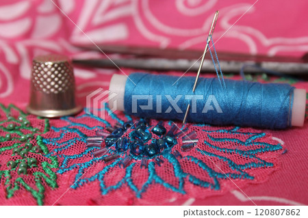 Spool of Blue Thread on Vintage Beaded Fabric 120807862