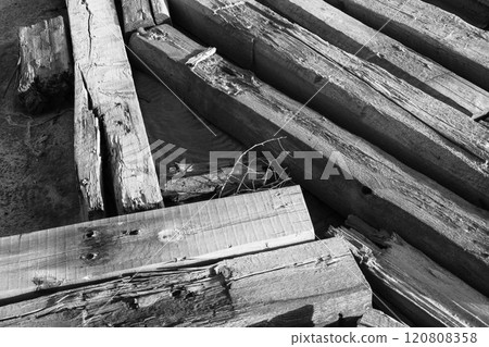 Close-up of weathered wooden beams in black and white composition 120808358