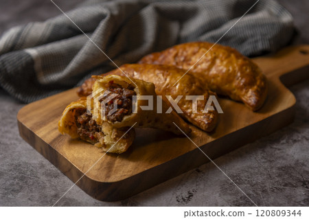 Meat pie on a cutting board Meat pie on a cutting board 120809344
