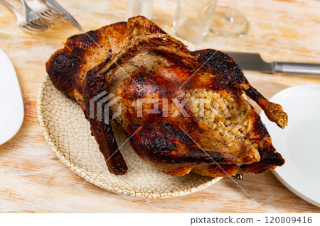 Browned baked duck stuffed with barley and mushrooms 120809416
