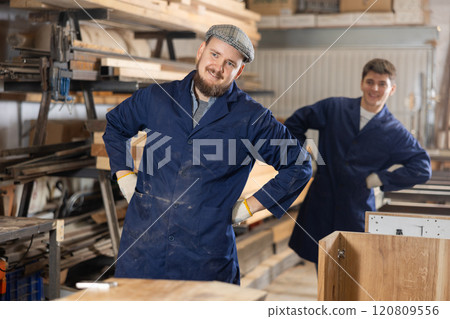 Two funny sawmill workers perform various funny moves Two funny sawmill workers perform various funny moves 120809556