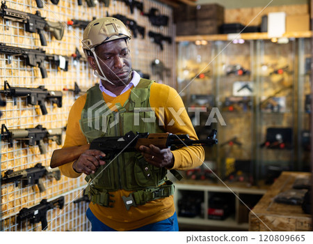 African american man in army uniform with weapon in military shop 120809665