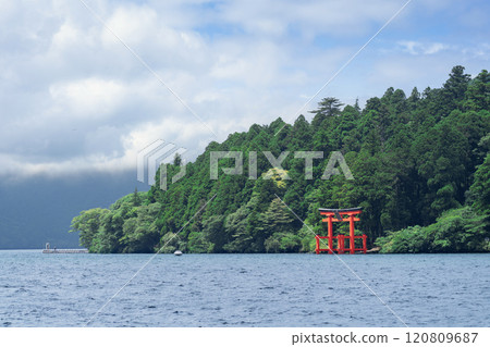 Beautiful serene lake with lush green forest and torii gate Beautiful serene lake with lush green forest and torii gate 120809687