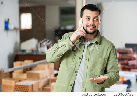 Civil engineer is talking on the phone 120809735