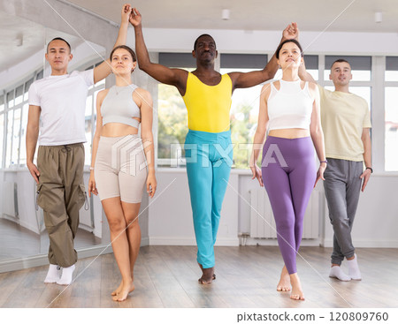 Young and middle-aged men and women practicing Irish dance in training hall 120809760