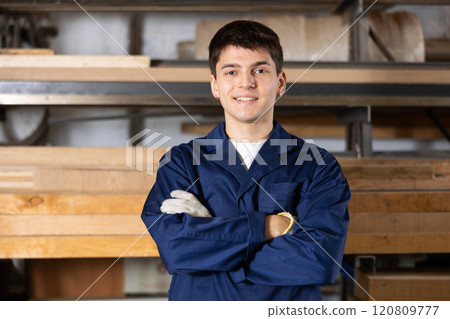 Portrait of young positive worker of furniture factory in production workshop Portrait of young positive worker of furniture factory in production workshop 120809777