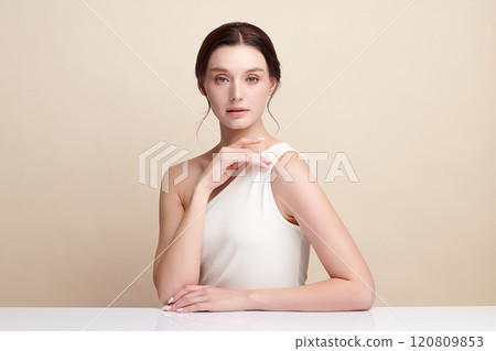 Beautiful young woman with clean fresh skin on beige background, Face care, Facial treatment, Cosmetology, beauty and spa, women portrait. Beautiful young woman with clean fresh skin on beige background, Face care, Facial treatment, Cosmetology, beauty and spa, women portrait. 120809853