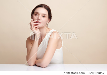 Beautiful young woman with clean fresh skin on beige background, Face care, Facial treatment, Cosmetology, beauty and spa, women portrait. Beautiful young woman with clean fresh skin on beige background, Face care, Facial treatment, Cosmetology, beauty and spa, women portrait. 120809857