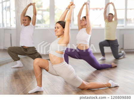 Young woman doing leg exercises in training hall 120809880