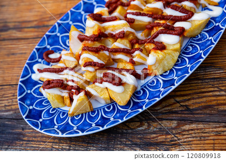 Baked in oven spanish tapas potatoes bravas baked with tomato sauce Baked in oven spanish tapas potatoes bravas baked with tomato sauce 120809918