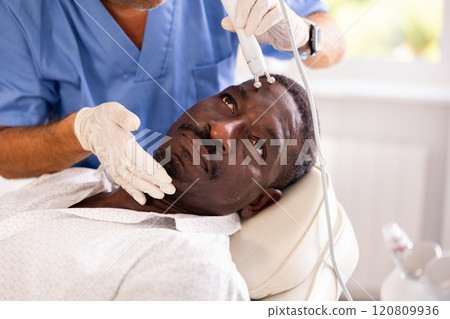 Doctor uses RF-lifting beauty machine nozzle for stimulate collagen production Doctor uses RF-lifting beauty machine nozzle for stimulate collagen production 120809936