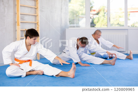 Group of men doing stretching in studio 120809965