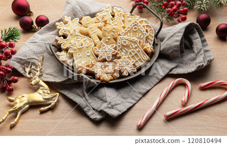 Christmas gingerbread cookies decorated with icing on wooden table 120810494