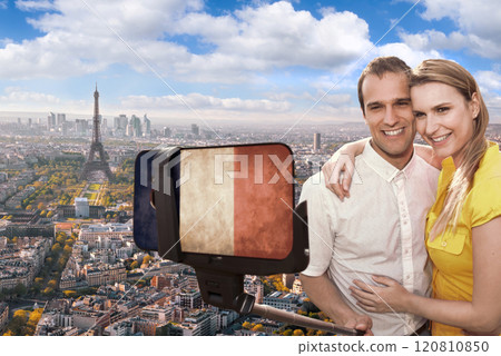 Happy couple of tourists taking selfie photo with cellphone covered a French flag in front of Eiffel Tower in Paris, France Happy couple of tourists taking selfie photo with cellphone covered a French flag in front of Eiffel Tower in Paris, France 120810850