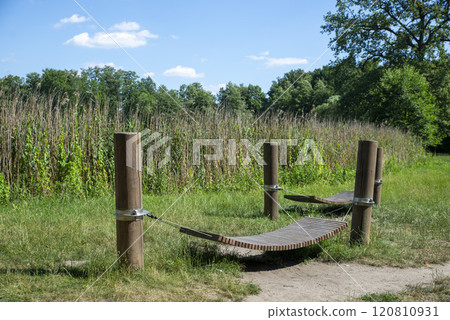 Relaxation Spot in Nature with Wooden Hammock 120810931