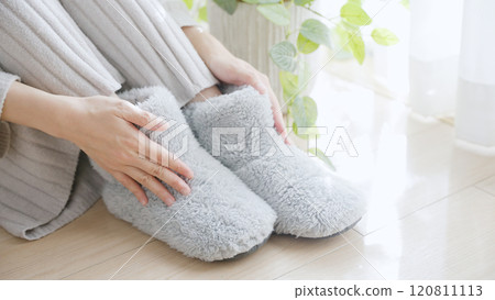 A woman with poor circulation wearing room shoes A woman with poor circulation wearing room shoes 120811113