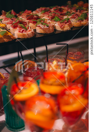 catering buffet table with snacks and appetizers. Set of canapes with jamon, bruschetta, pear and cheese catering buffet table with snacks and appetizers. Set of canapes with jamon, bruschetta, pear and cheese 120811145
