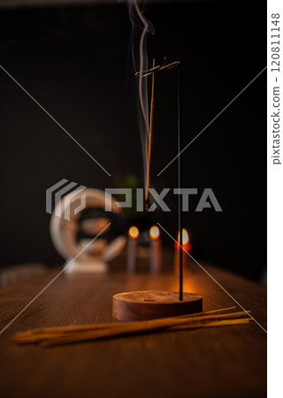 Burning aromatic incense smoky stick for meditation and relaxing. Aromatherapy smoke for yoga concept. 120811148