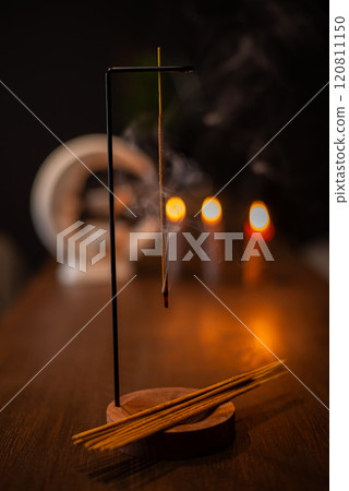 Burning aromatic incense smoky stick for meditation and relaxing. Aromatherapy smoke for yoga concept. 120811150