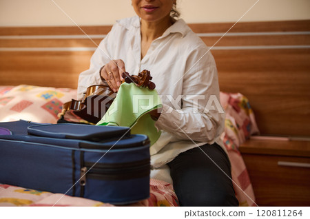 Woman preparing a violin in a cozy bedroom setting Woman preparing a violin in a cozy bedroom setting 120811264