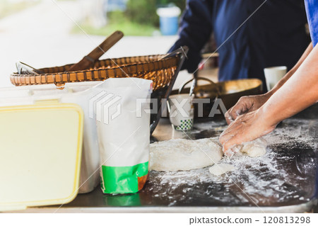 Homemade hand preparing bread dough on  table. 120813298