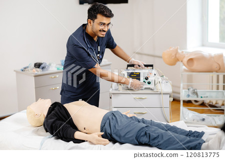 Doctors analyzing medical dummy in hospital setting Doctors analyzing medical dummy in hospital setting 120813775