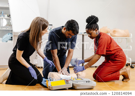Healthcare professionals in scrubs performing medical procedure Healthcare professionals in scrubs performing medical procedure 120814094
