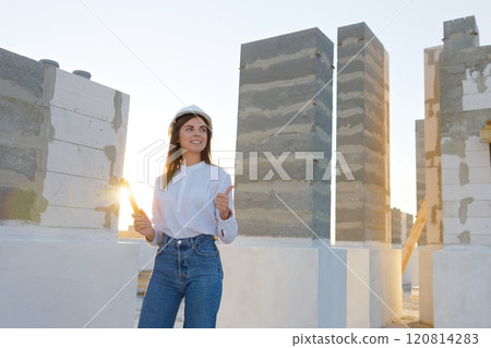 Woman architect gesturing thumbs up at construction site Woman architect gesturing thumbs up at construction site 120814283