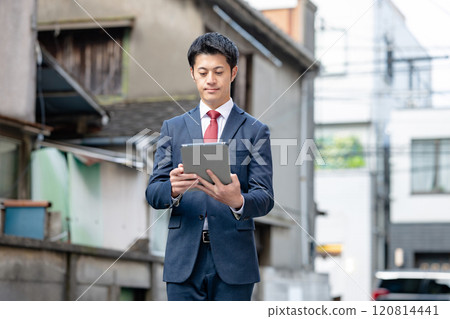 A businessman with a tablet 120814441