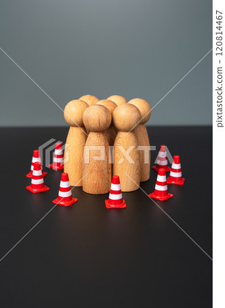 A group of people are surrounded by restrictive road cones. Rights and freedoms. Limitations and boundaries. 120814467