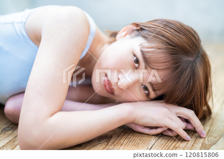 A young woman with a short bob lying on the floor A young woman with a short bob lying on the floor 120815806
