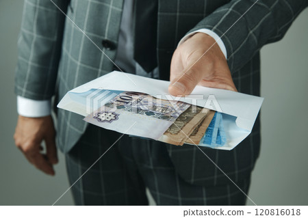 businessman offering an envelope with forints businessman offering an envelope with forints 120816018
