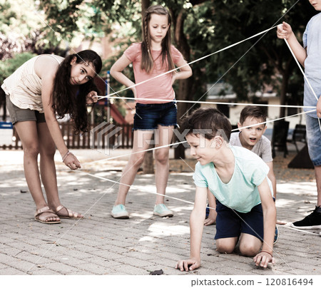 Children games. Girl goes through the tangled rope Children games. Girl goes through the tangled rope 120816494