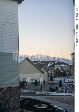 Sunlit Mountain Peaks Framed by an Apartment Complex in Salt Lake City at Sunset 120816589