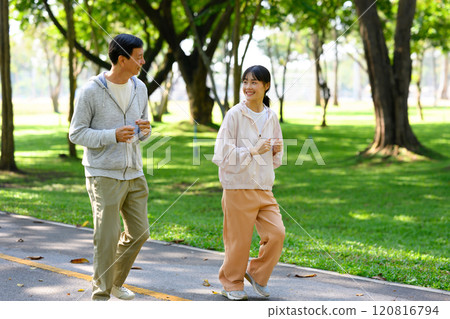 Cheerful father and daughter jogging on a sunny park path. Health and family activity concept Cheerful father and daughter jogging on a sunny park path. Health and family activity concept 120816794