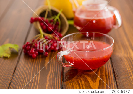 tea from ripe red viburnum on a wooden table 120816927