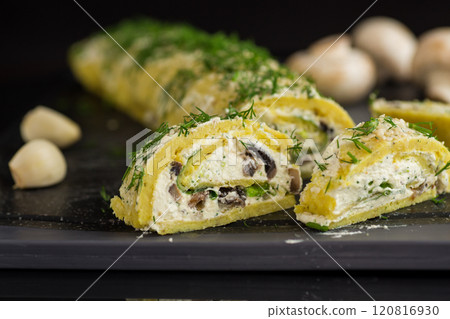 baked potato roll with cottage cheese filling with garlic and mushrooms, isolated on black background 120816930