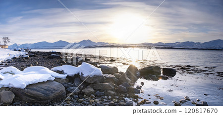 Snow covered Robukta coast of Norwegian fjord near Troms at Christmas time. A sunny winter day in Northern Norway above the Arctic Circle Snow covered Robukta coast of Norwegian fjord near Troms at Christmas time. A sunny winter day in Northern Norway above the Arctic Circle 120817670