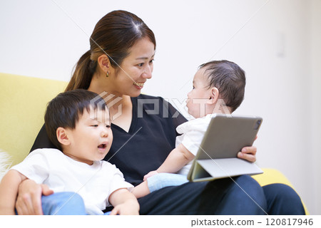 Parents and children looking at tablet screen Parents and children looking at tablet screen 120817946