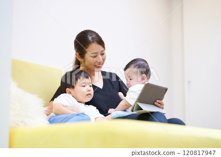 Parents and children looking at tablet screen Parents and children looking at tablet screen 120817947