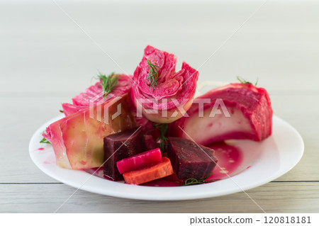 pickled cabbage with beets and carrots, in a plate, on a wooden table pickled cabbage with beets and carrots, in a plate, on a wooden table 120818181