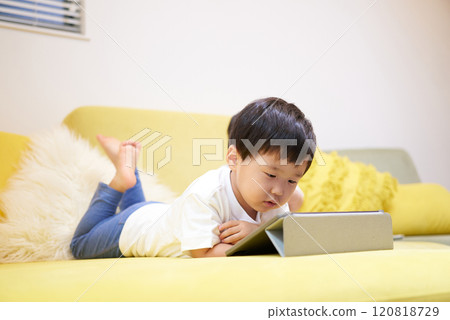 Boy looking at tablet screen 120818729