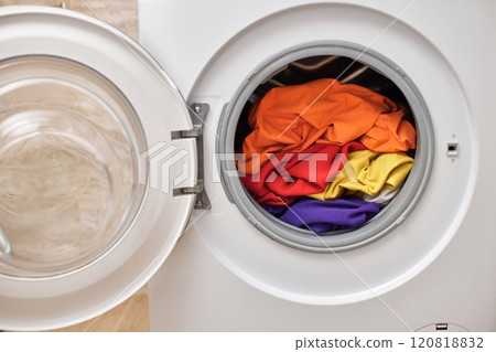 Colorful clothes inside washing machine with open door. laundry close up. 120818832