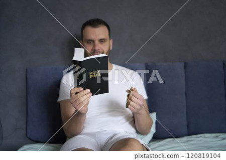 30-year-old man reads the Bible and prays in bed, morning routine 120819104